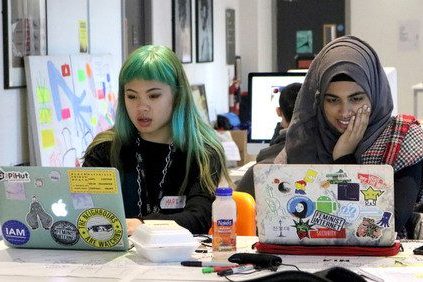 Girls together on their laptops